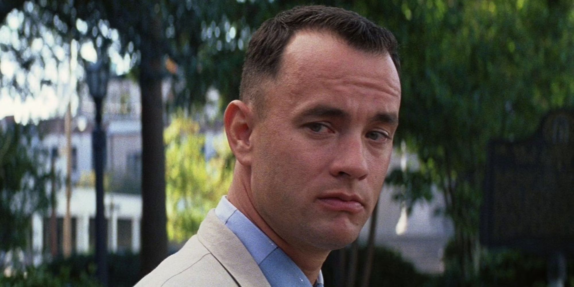 Tom Hanks as Forest Gump sitting on a bench