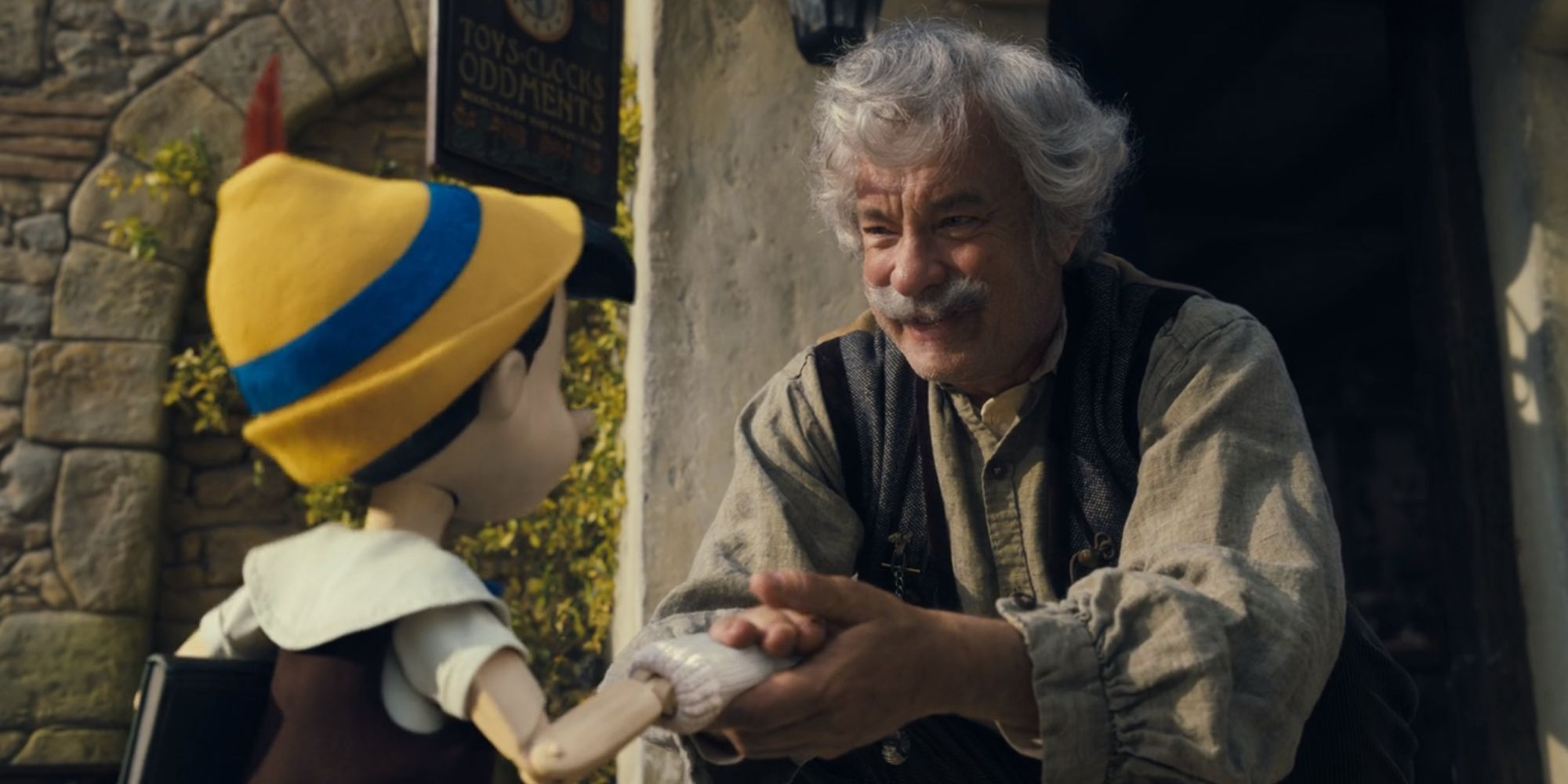 Tom Hanks as Geppetto saying goodbye to Pinocchio in the live-action remake of Pinocchio (2022)