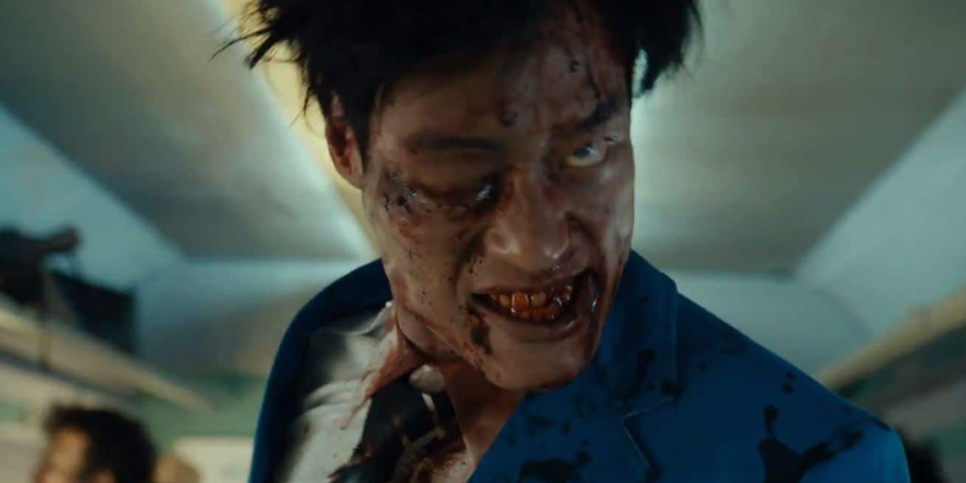 This image shows a closeup of a one-eyed zombie in a suit in the movie Train to Busan.