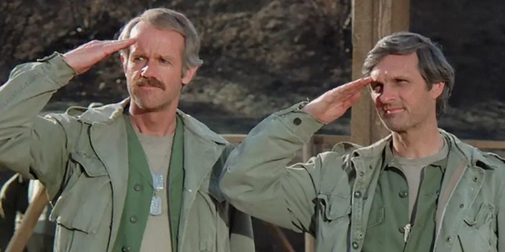 Two men do the salute gesture in MASH 
