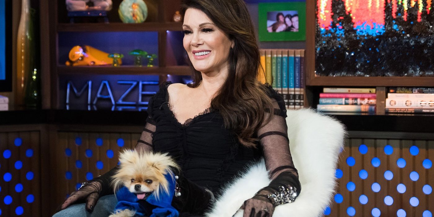 Lisa Vanderpump and her dog Giggy on WWHL, wearing a black dress while Giggy wears a blue outfit