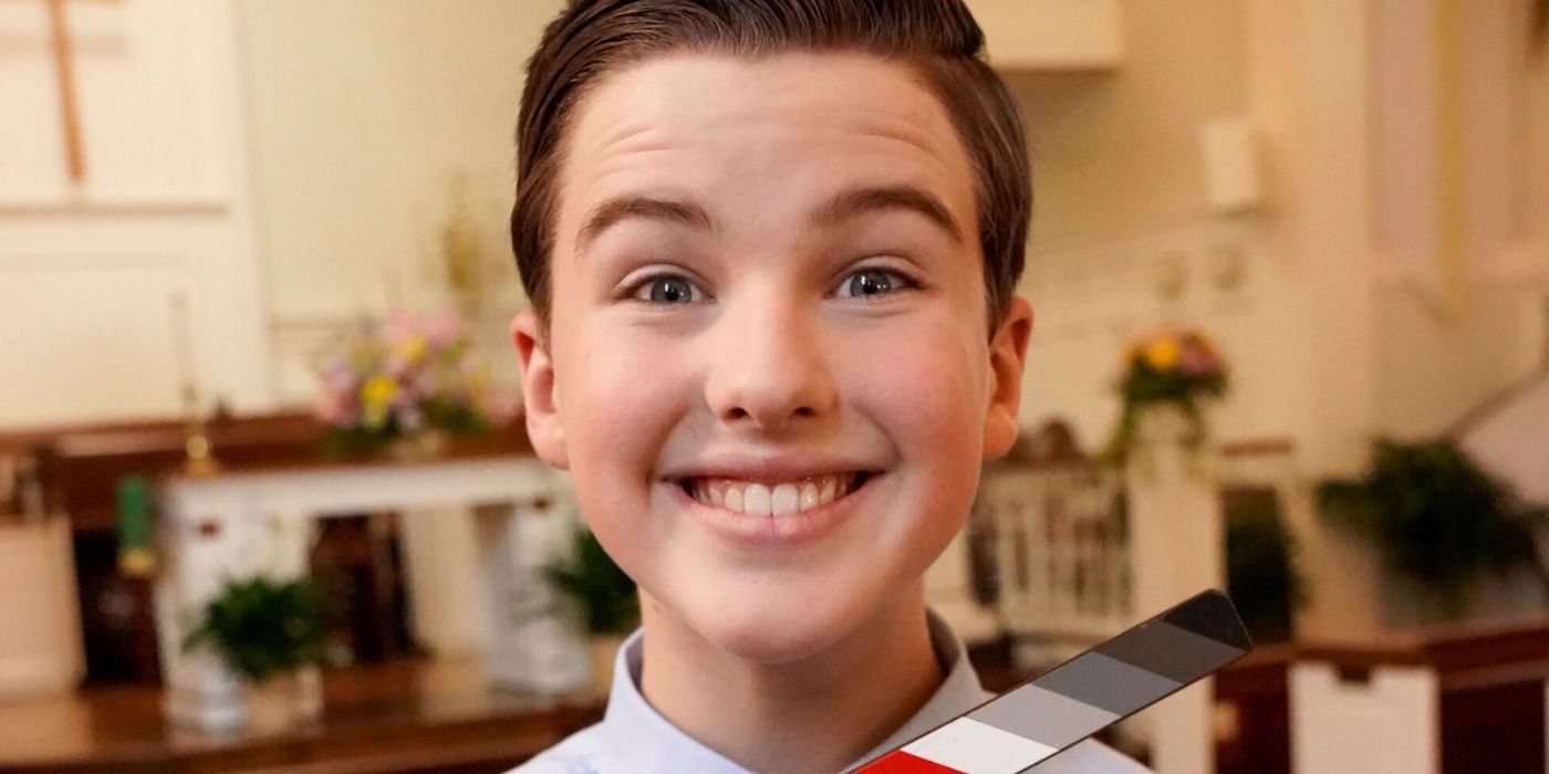 Young Sheldon season 6 BTS image features Iain Armitage as Sheldon Cooper Smiling with the church in the background