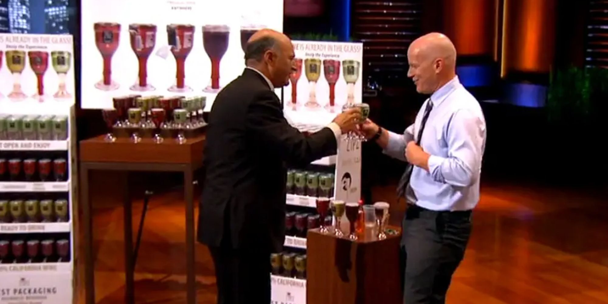 Kevin makes a toast with the Zipz founder in Shark Tank