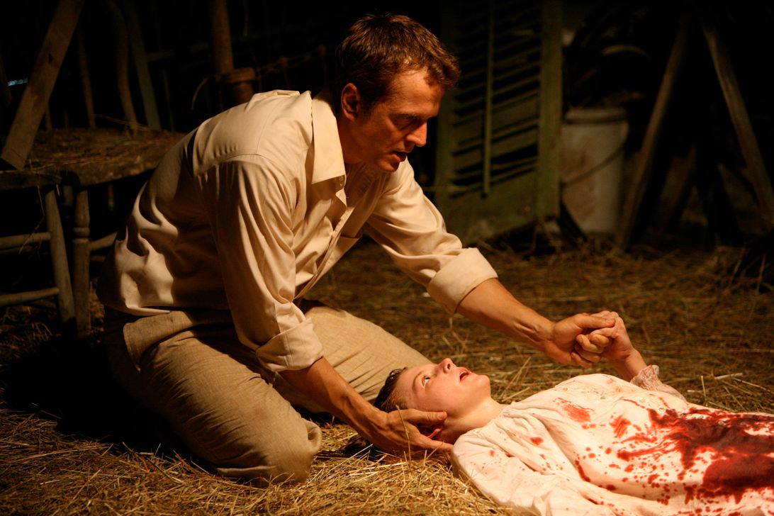 Cotton Marcus over a bleeding woman in the last exorcism