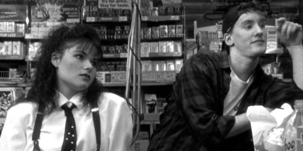 Caitlyn stands by Randal by the check out counter in Clerks