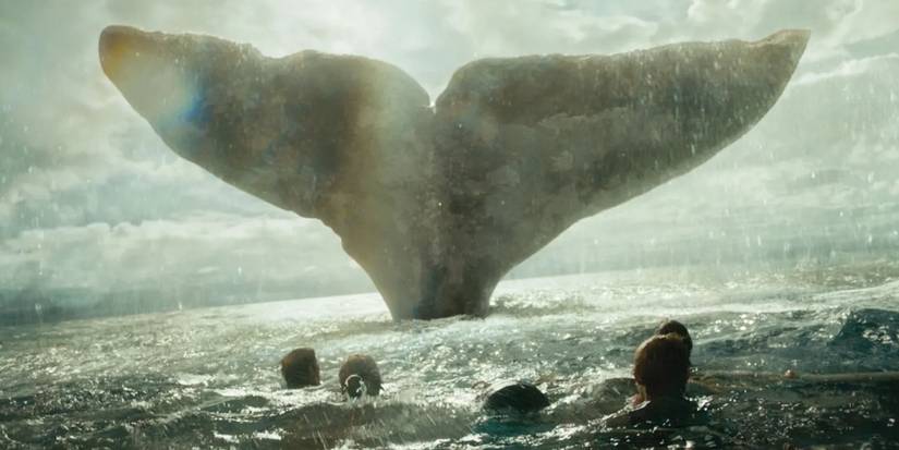 Men in the Water Gazing at the Giant Tail of a Whale in In the Heart of the Sea