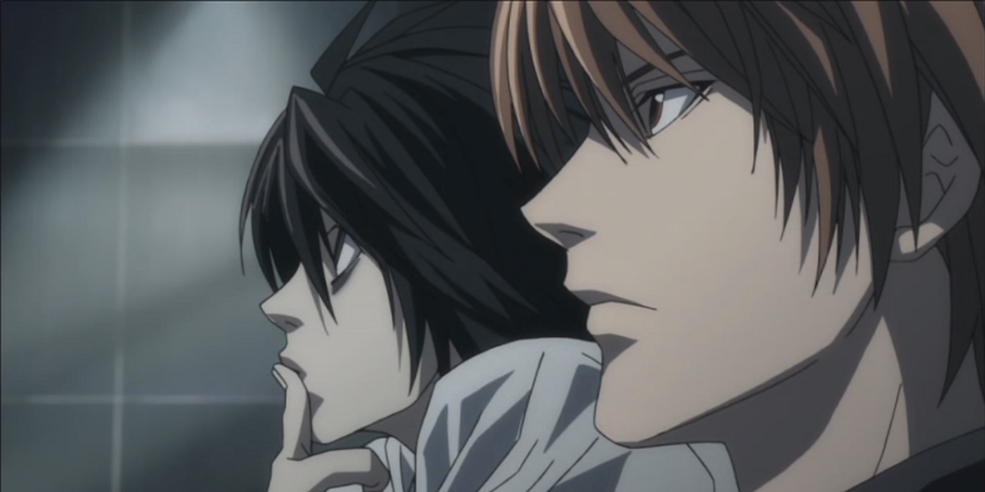 L and Light Yagami from Death Note sitting beside one another.