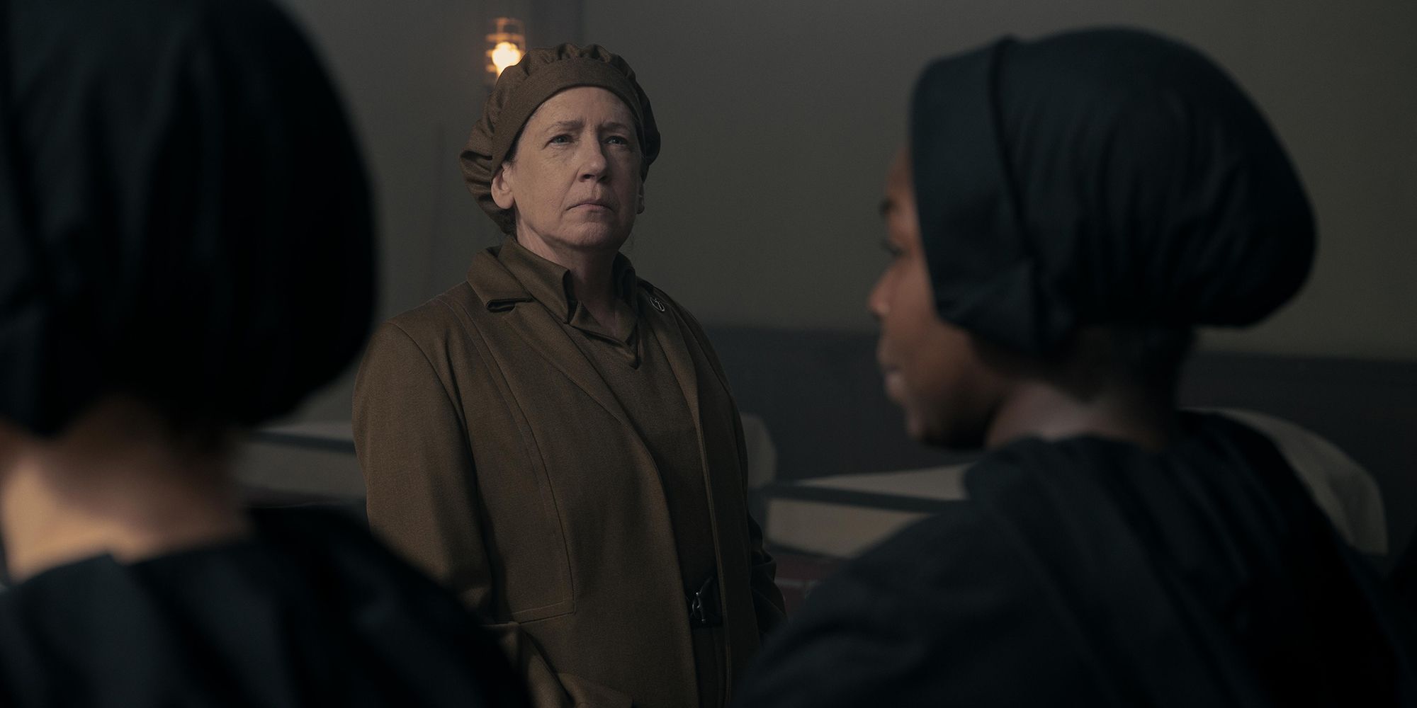 Aunt Lydia from The Handmaid's Tale, looking sternly at handmaids.