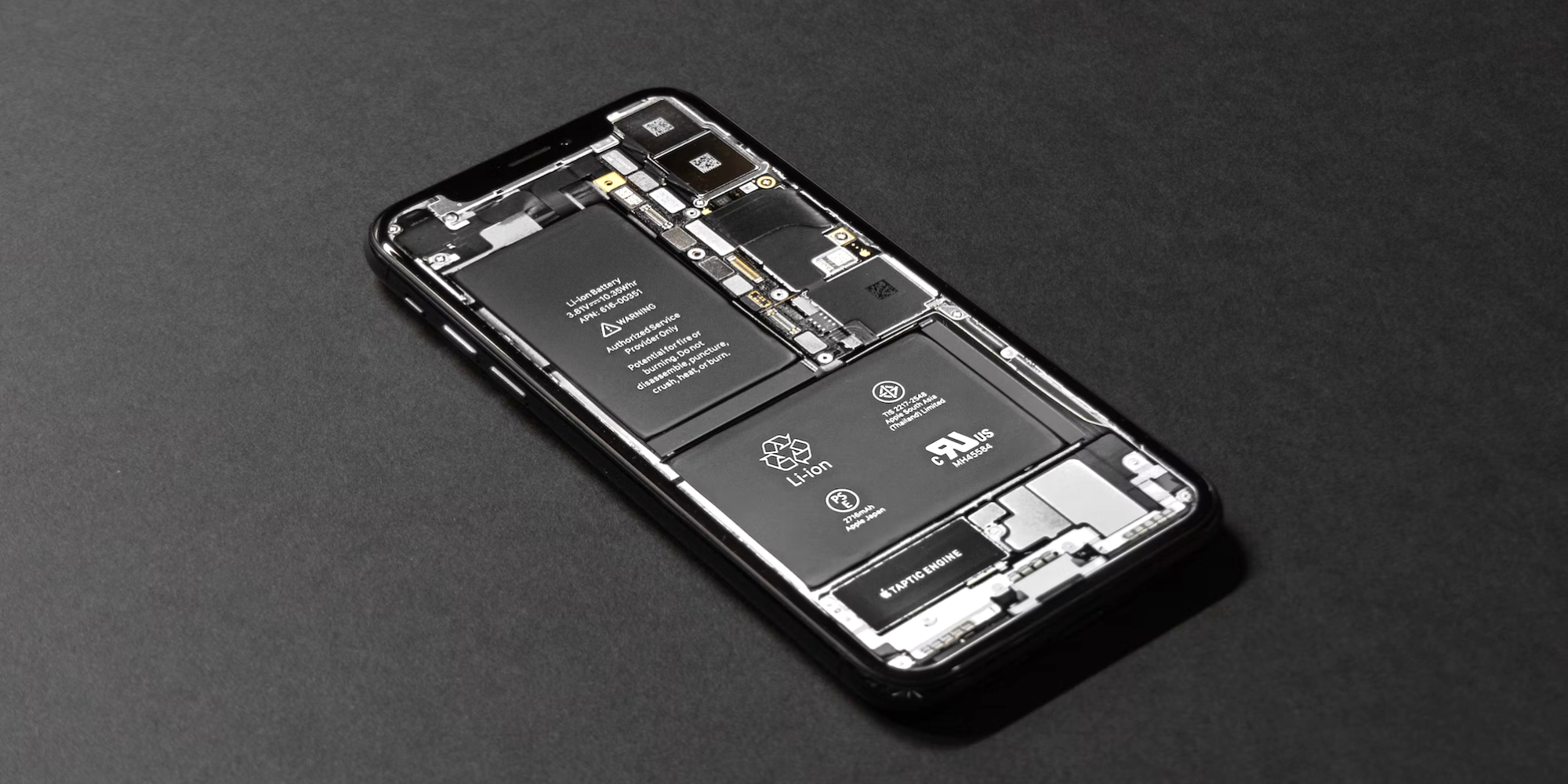iPhone 14 with the back casing removed to show the internal battery setup