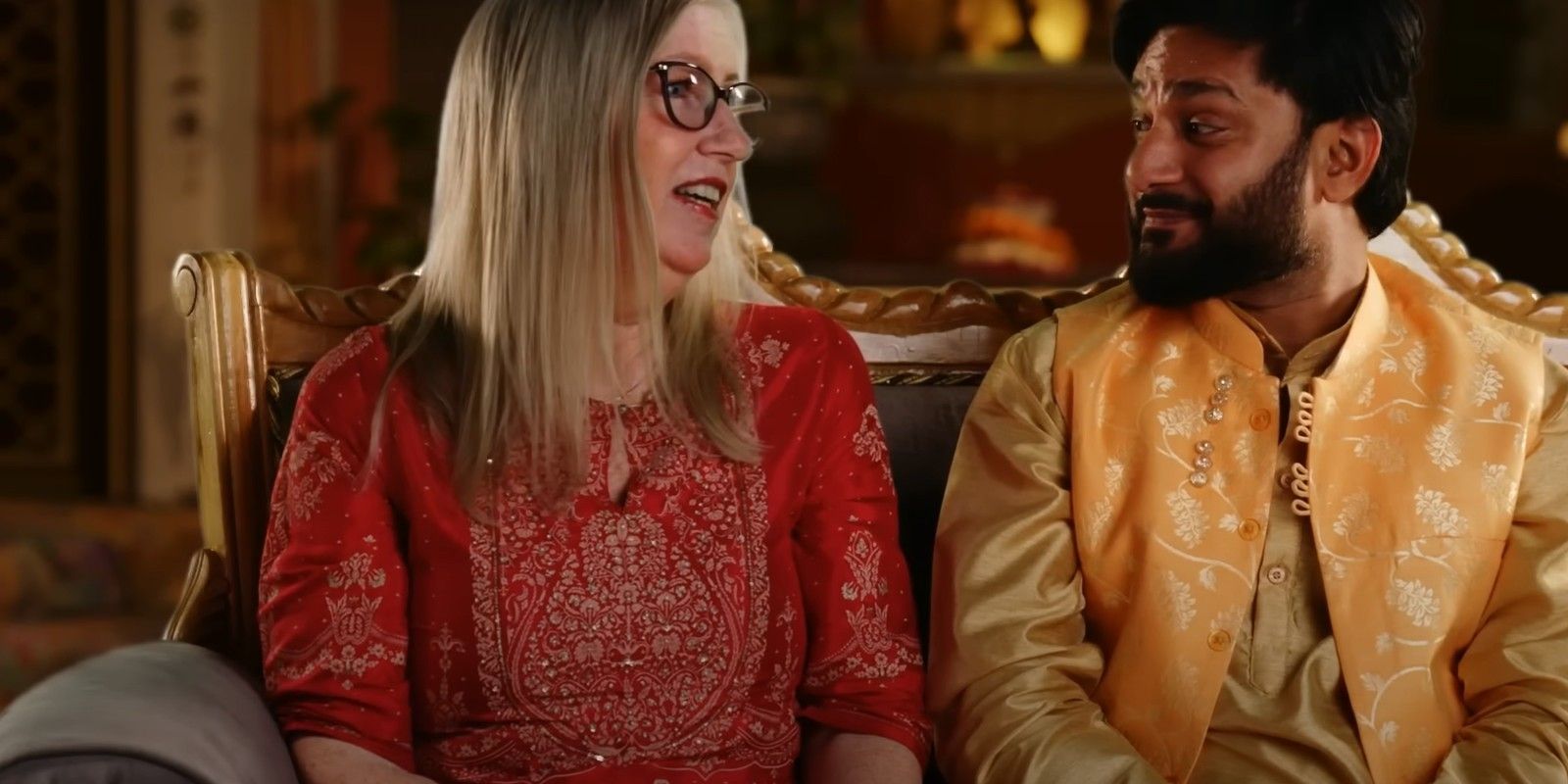 90 Day Fiancé Jenny Slatten and Sumit Singh smiling on couch