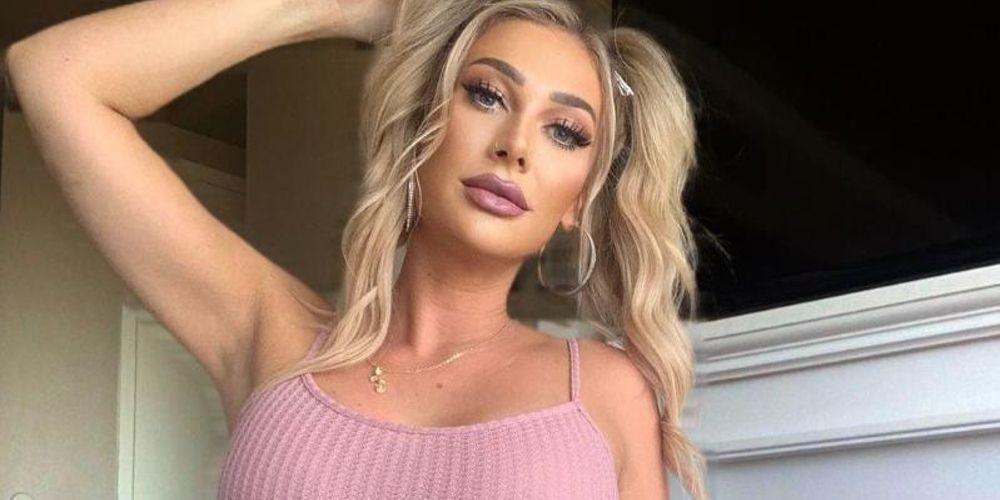 Love Island's Olivia Kaiser poses at home in a pink tank top
