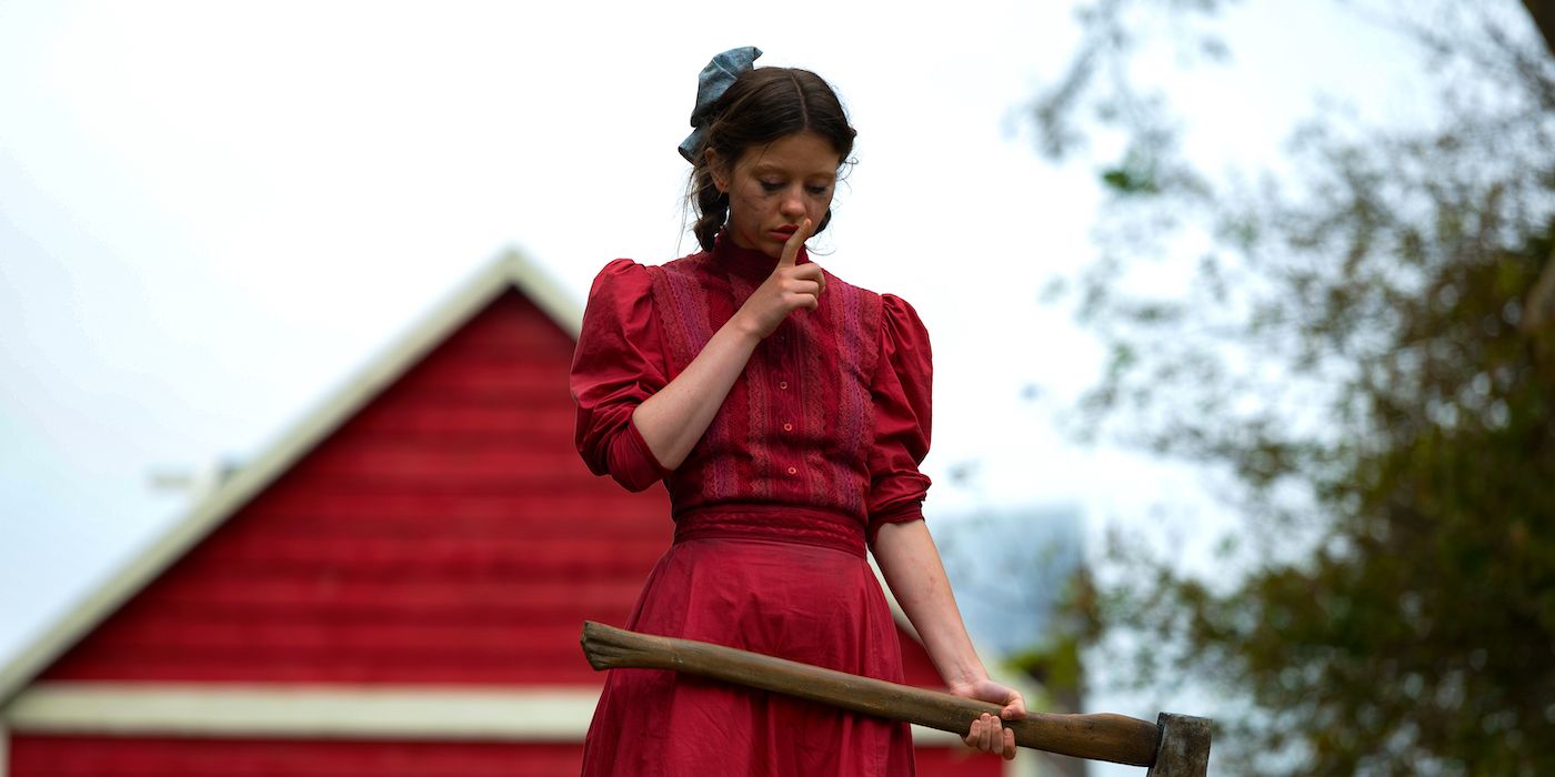 Mia Goth standing holding an ax in Pearl.