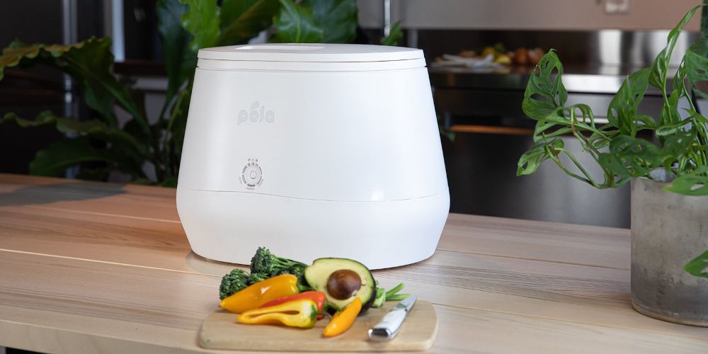 Pela's Lomi compost device is displayed on a kitchen counter