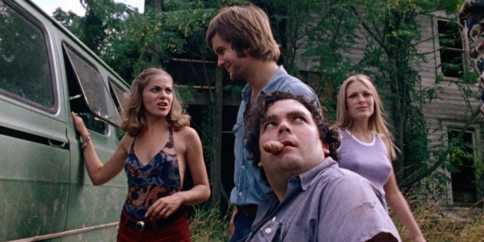 A group of people stand near a vehicle looking scared in The Texas Chainsaw Massacre (1974)