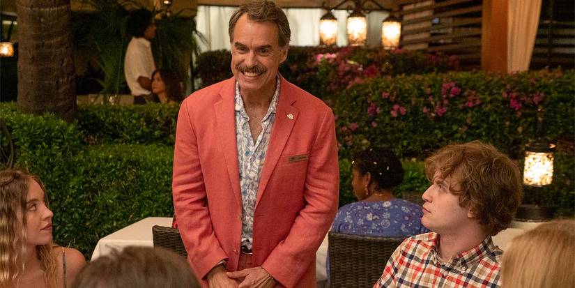 Armond smiling, greeting guests at a table at the restaurant on The White Lotus.