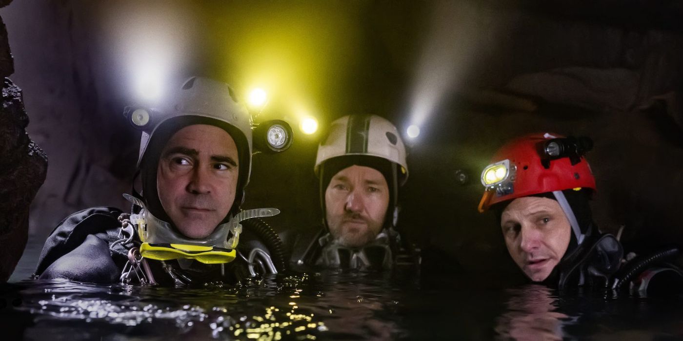 Colin Farrell, Joel Edgerton, and Viggo Mortensen in diving gear submerged in water up to their shoulders in Thirteen Lives