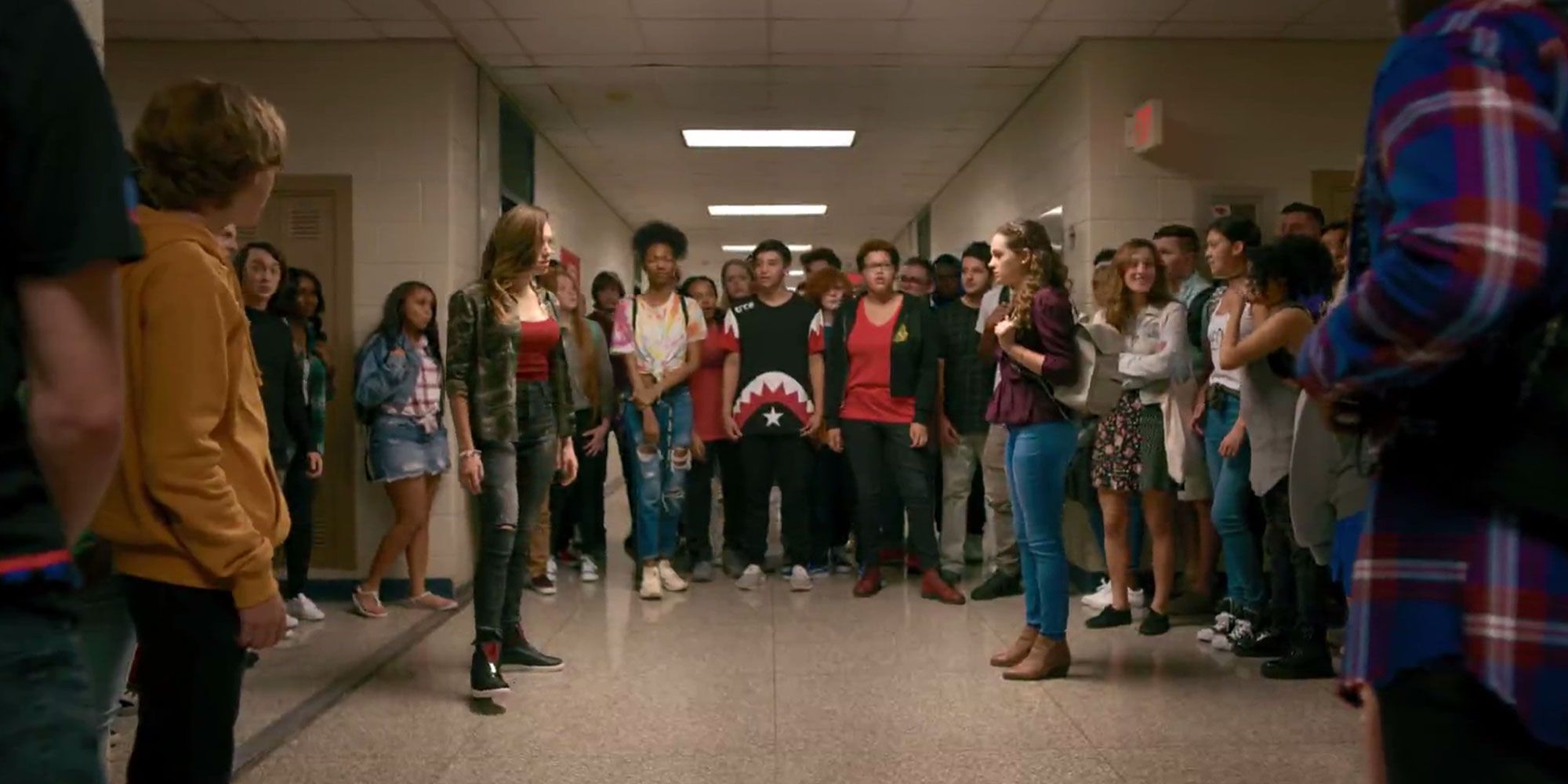 Tory and Sam face off in the school hallway in Cobra Kai