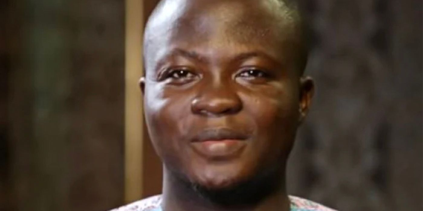 Michael Ilesanmi from 90 Day Fiancé smiling with mouth closed