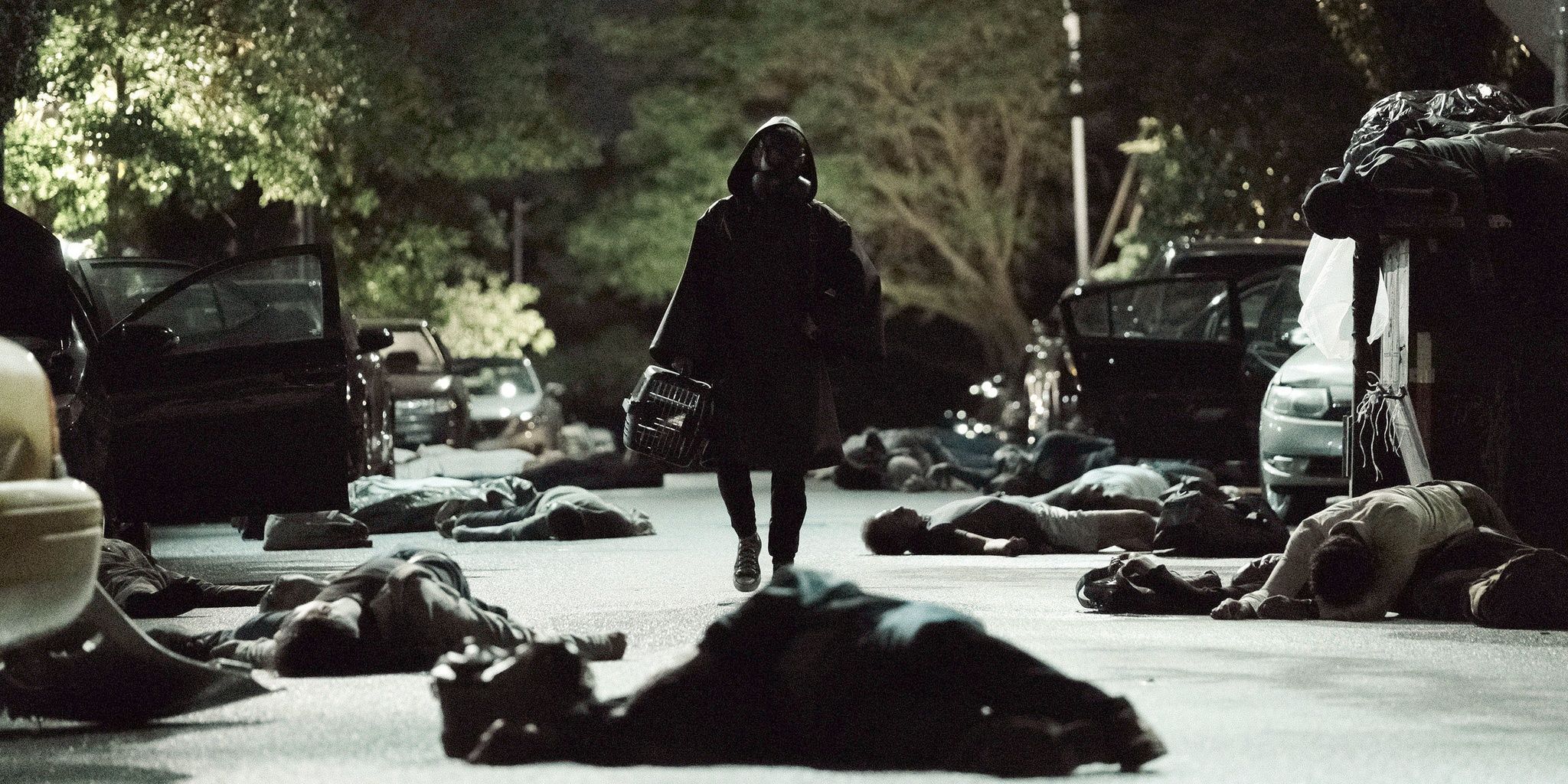 A hooded figure walks among bodies in Y The Last Man 