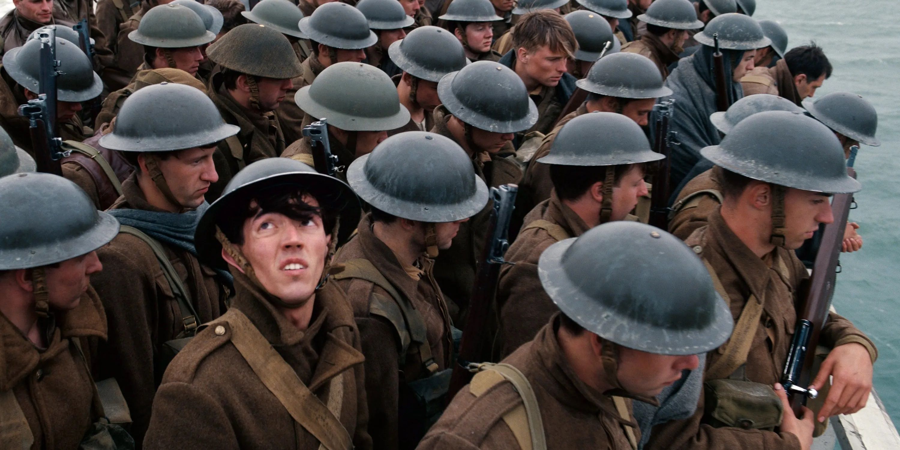 A soldier looking up amid a crowd of soldiers on a boat in Dunkirk