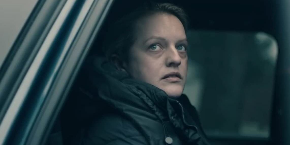 A woman looks outside the window of her car in The Handmaid's Tale 