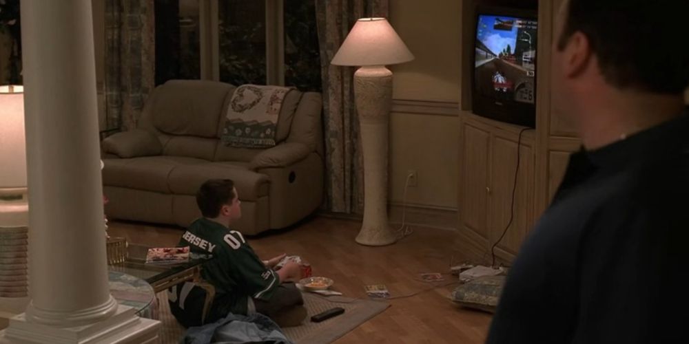 AJ joga videogame enquanto Tony assiste em The Sopranos