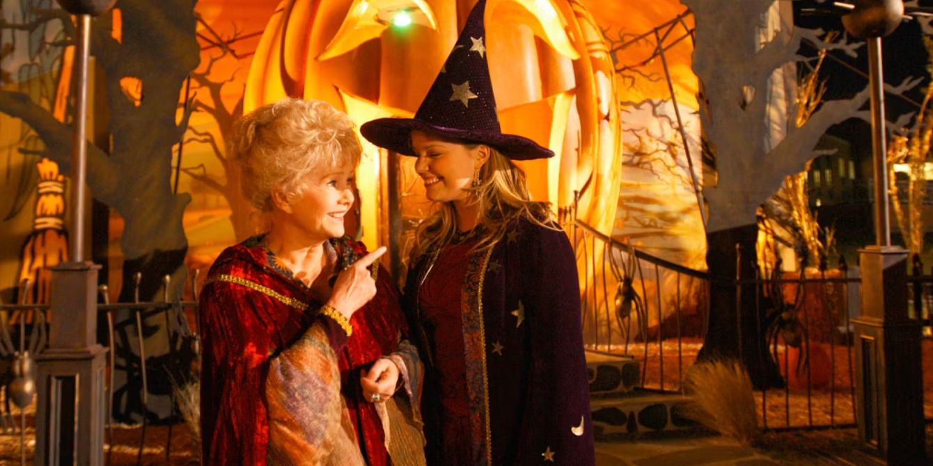 Aggie and Marnie in front of a giant pumpkin in Halloweentown High