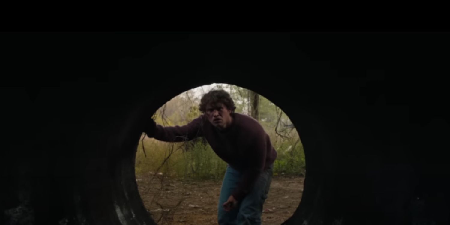 An image of Corey looking down a sewer in Halloween Ends