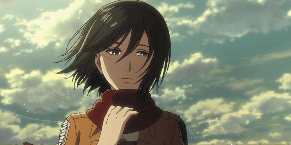 MIkasa toca seu cachecol ao ar livre em Attack on Titan