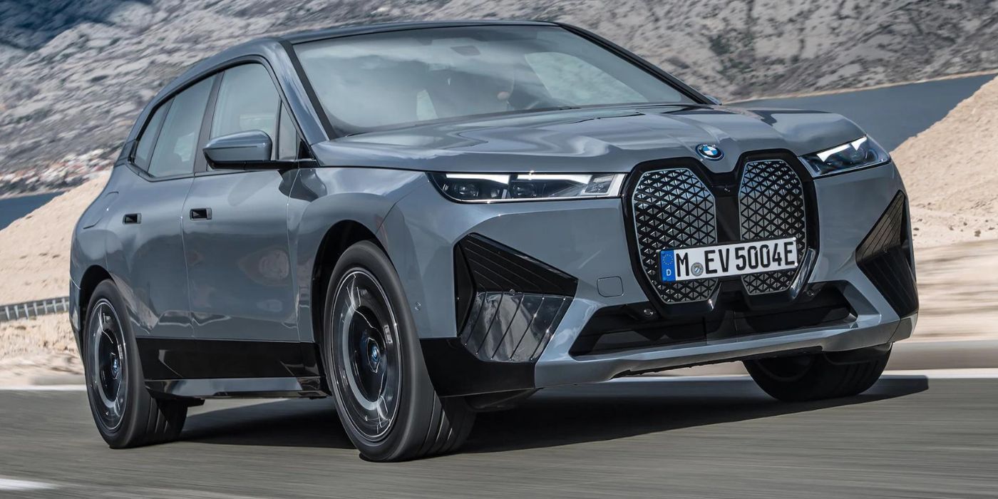 A BMW iX xDrive50 going down a road.