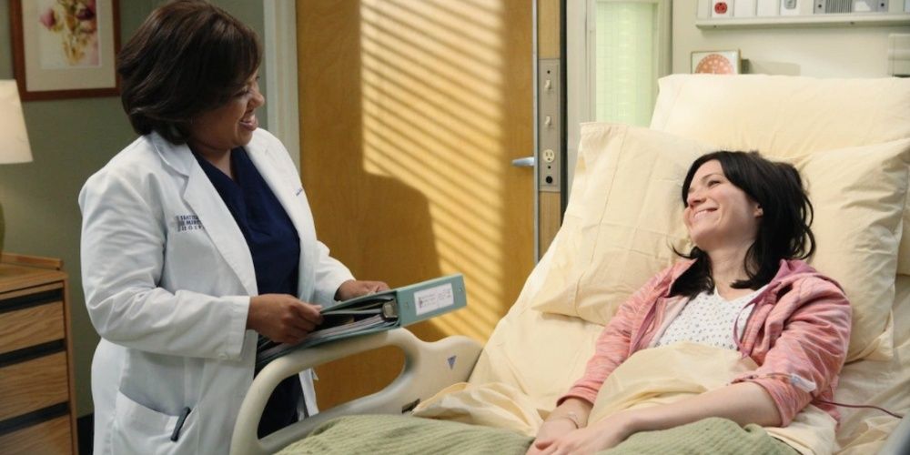 Bailey laughs with a patient in bed in Grey&rsquo;s Anatomy