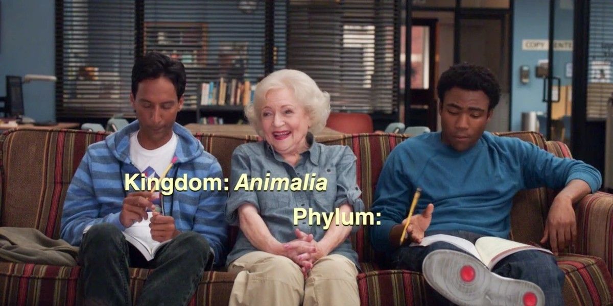 Betty White sitting on a couch with Troy and Abed in Community