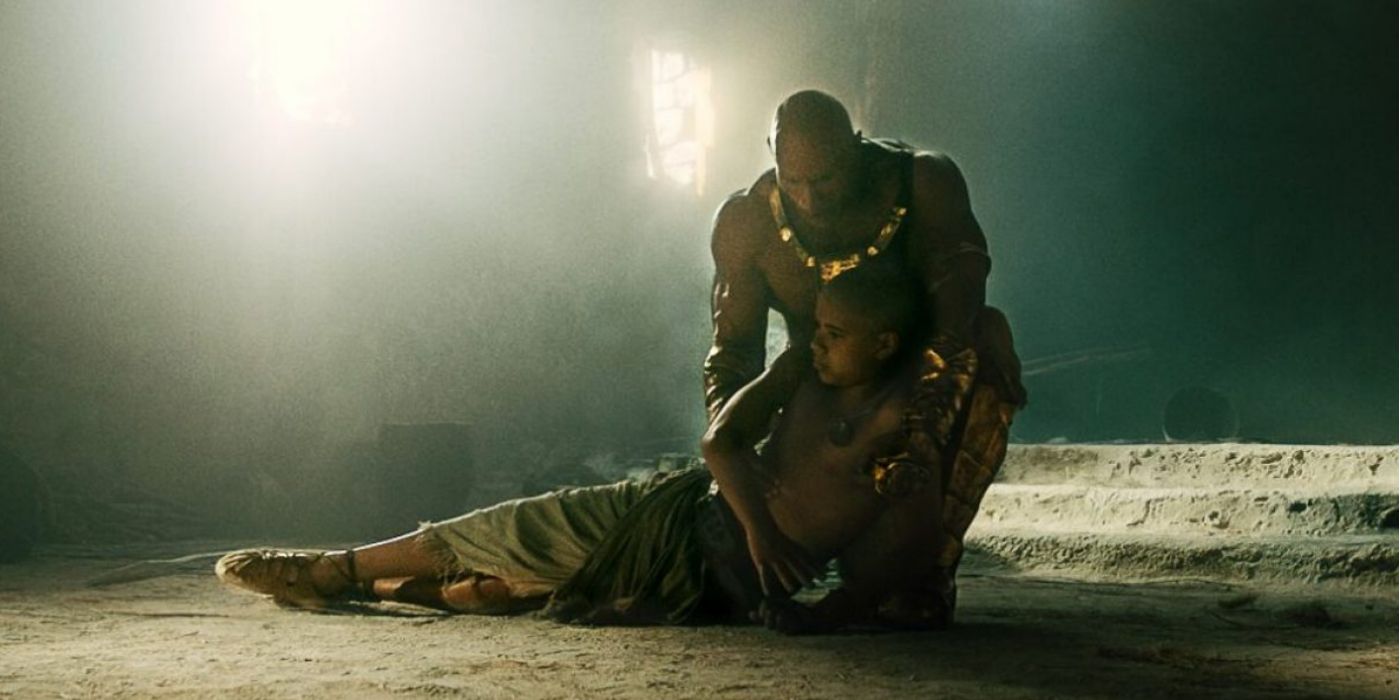 Black Adam holding Hurut as he dies