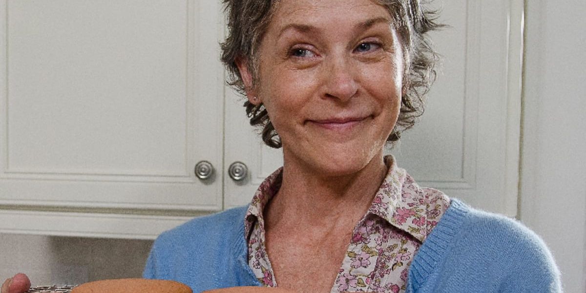 Carol smiles and holds up cookies in The Walking Dead