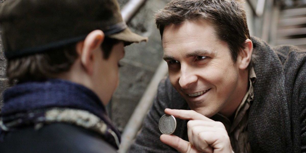 Christian Bale with a coin in The Prestige