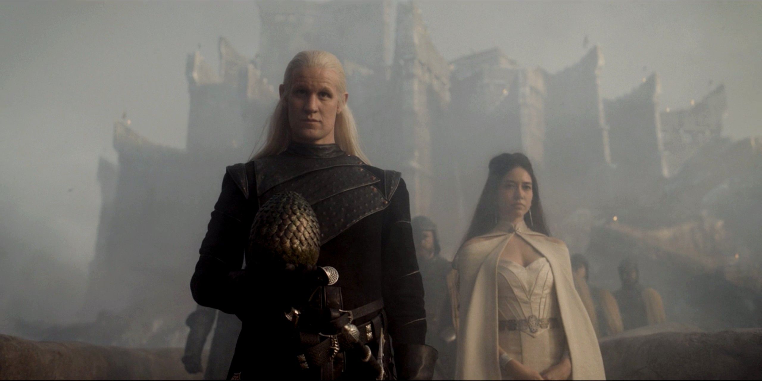 Daemon holing a dragon egg, followed by his mistress, on House of the Dragon