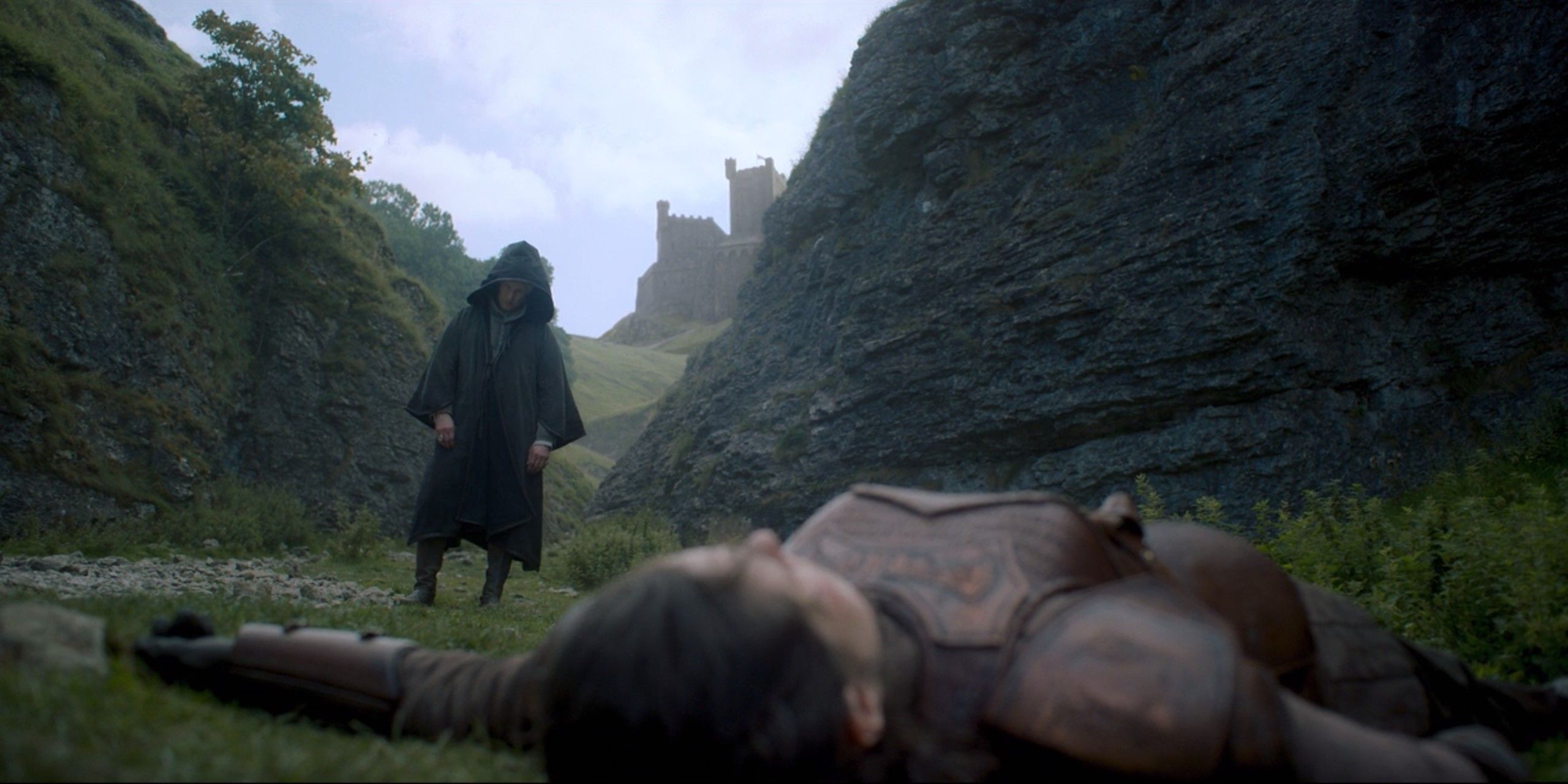 Daemon standing in the background, with Rhea in the foreground, dying, on House of the Dragon