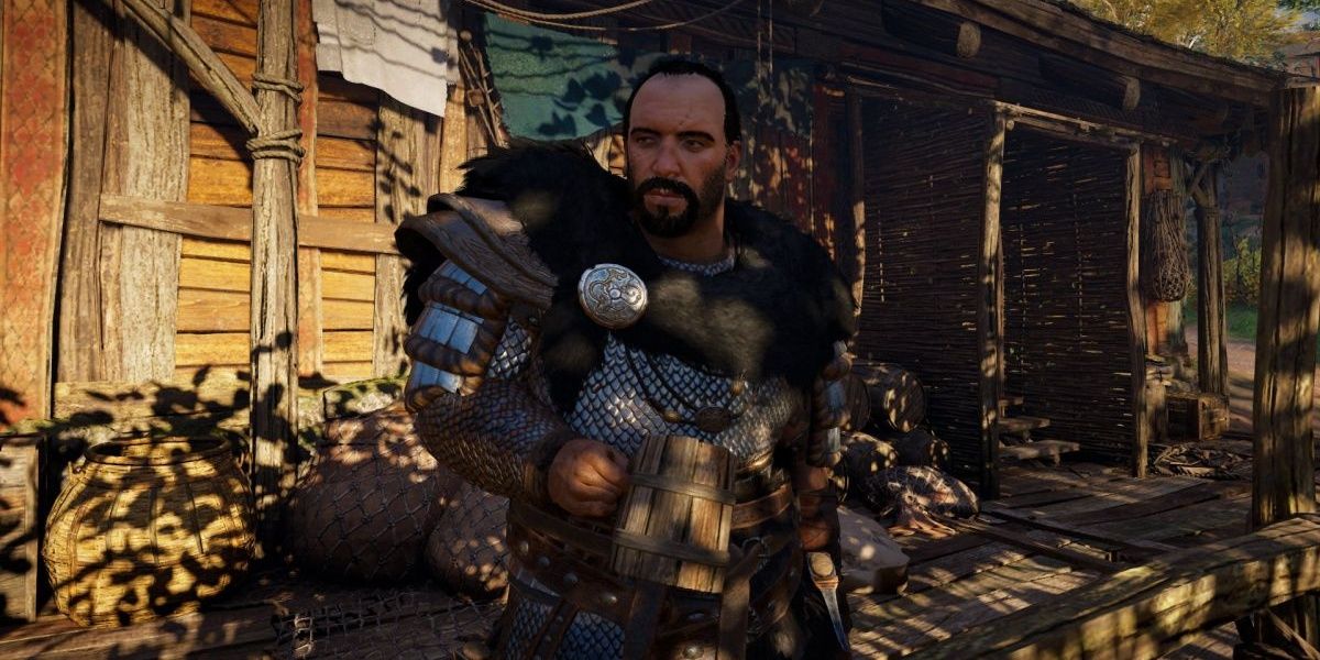 Dag Nithisson đứng bên ngoài ngôi nhà của mình trong Assassin's Creed Valhalla