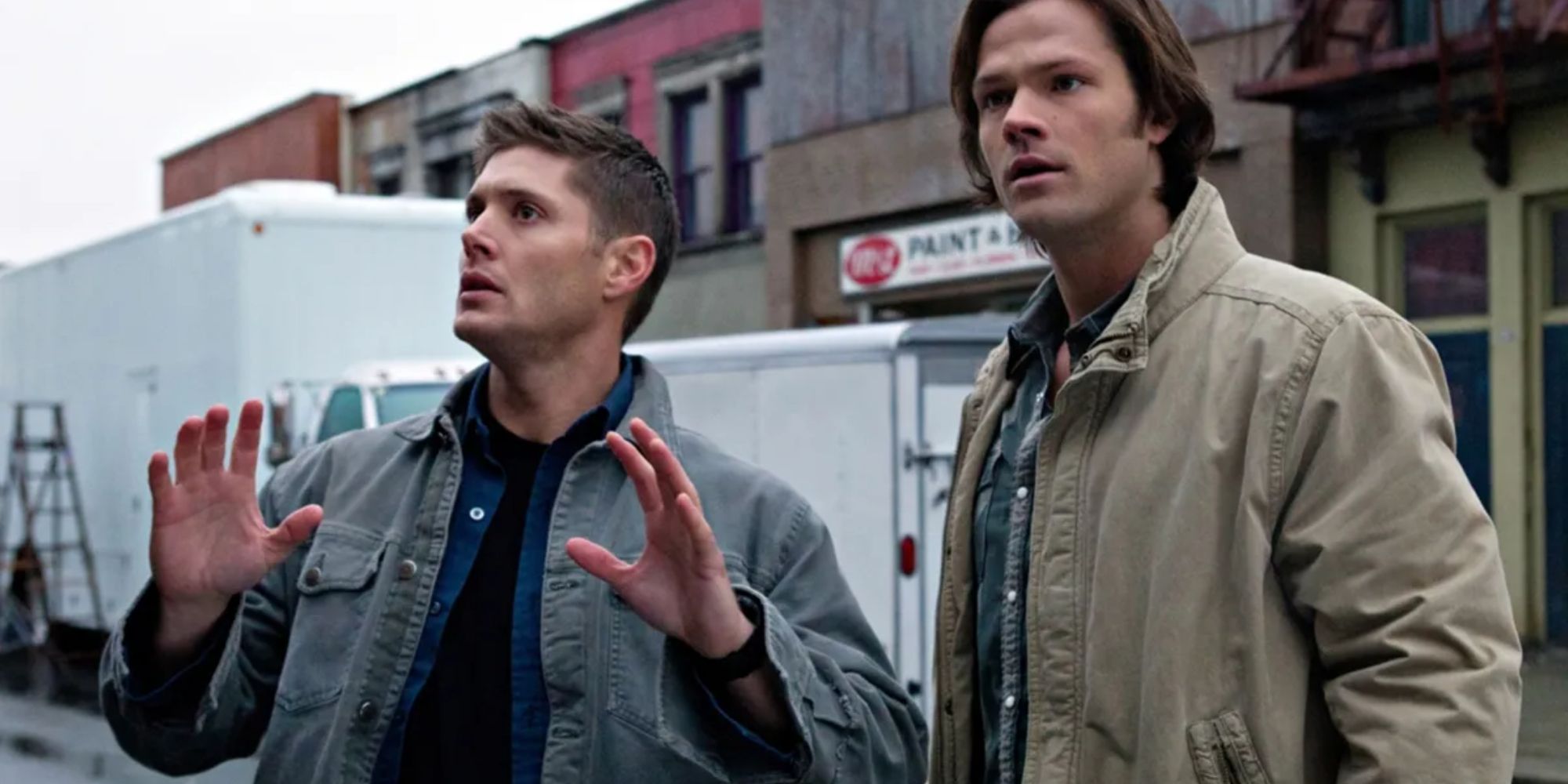 Dean and Sam looking around in Supernatural