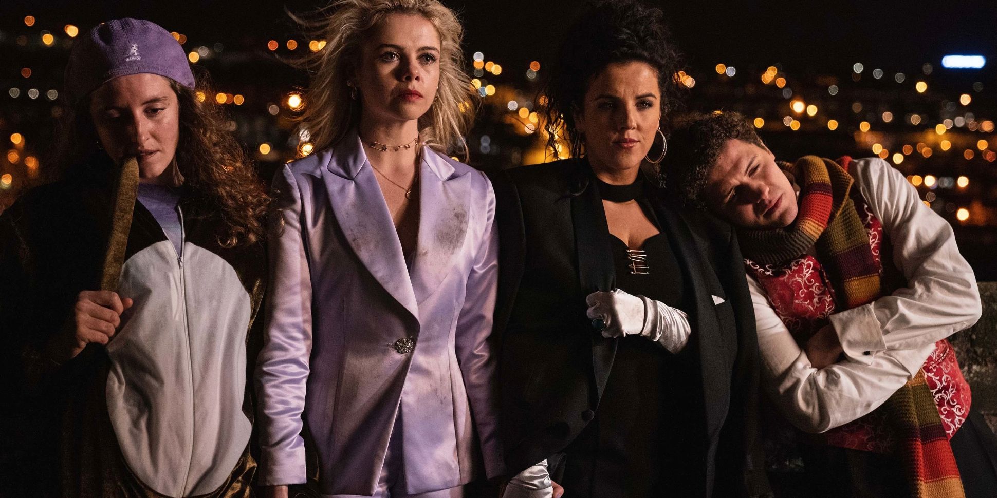 Orla, Erin, Michelle, and James stand together against the Derry skyline in Derry Girls series finale