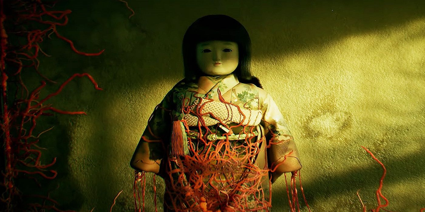 A Japanese doll being covered in red vines in Silent Hill f.