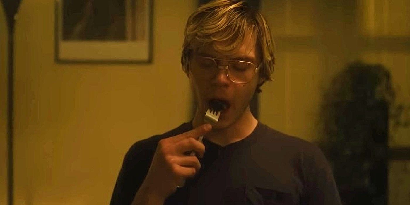 Evan Peters as Jeffrey Dahmer eating something on a fork in Monster on Netflix