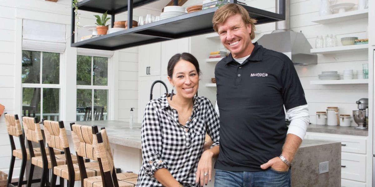 Chip and Jo pose inside a house they just renovated from Fixer Upper
