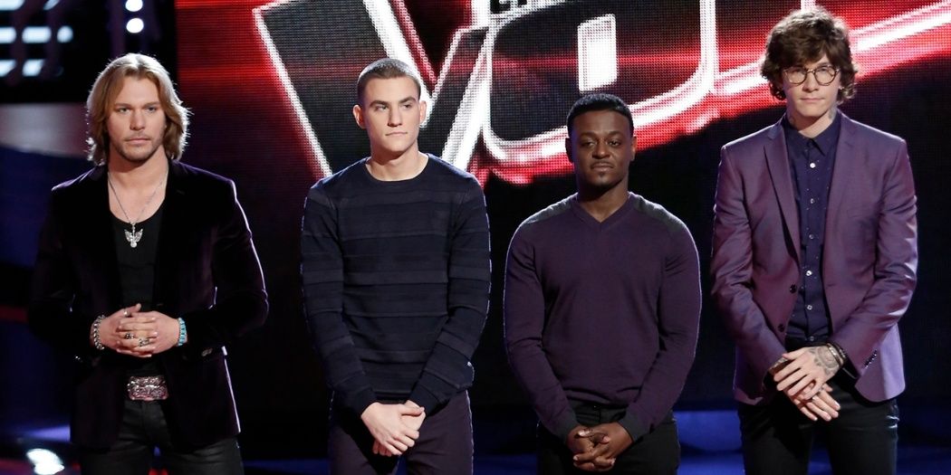 Four men stand on the stage in The Voice