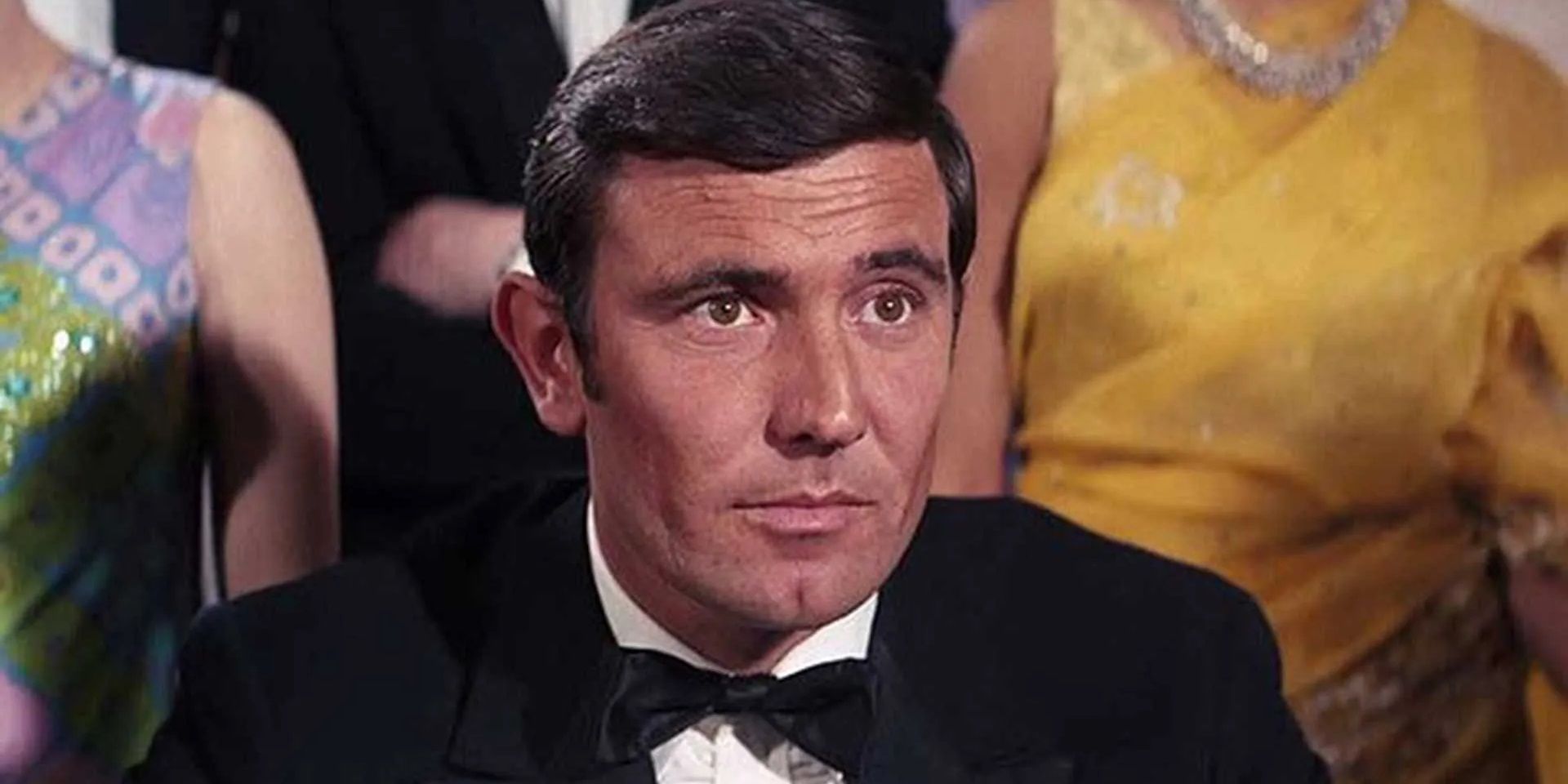 George Lazenby as James Bond wearing a tuxedo