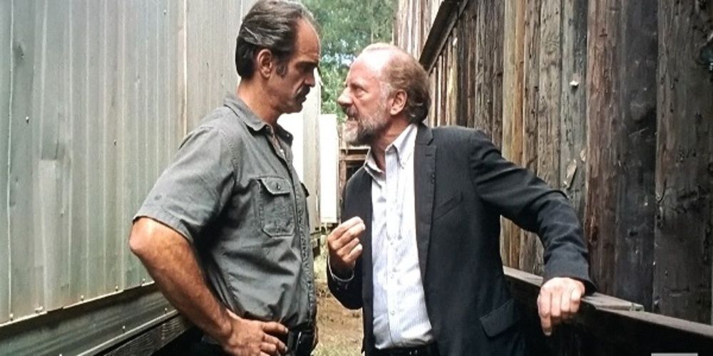 Gregory talks to Simon in an alley in The Walking Dead