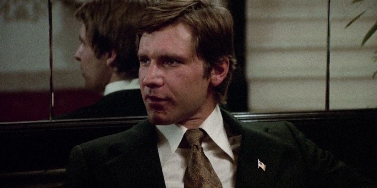 Harrison Ford sitting in a booth in The Conversation