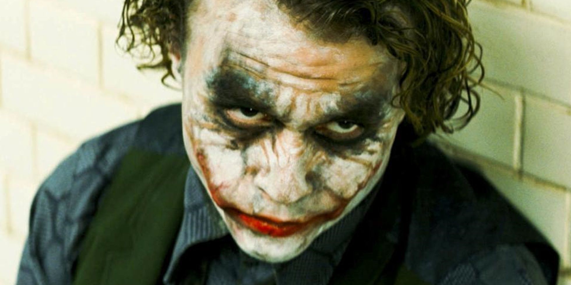 Heath Ledger as the Joker in an interrogation room in The Dark Knight