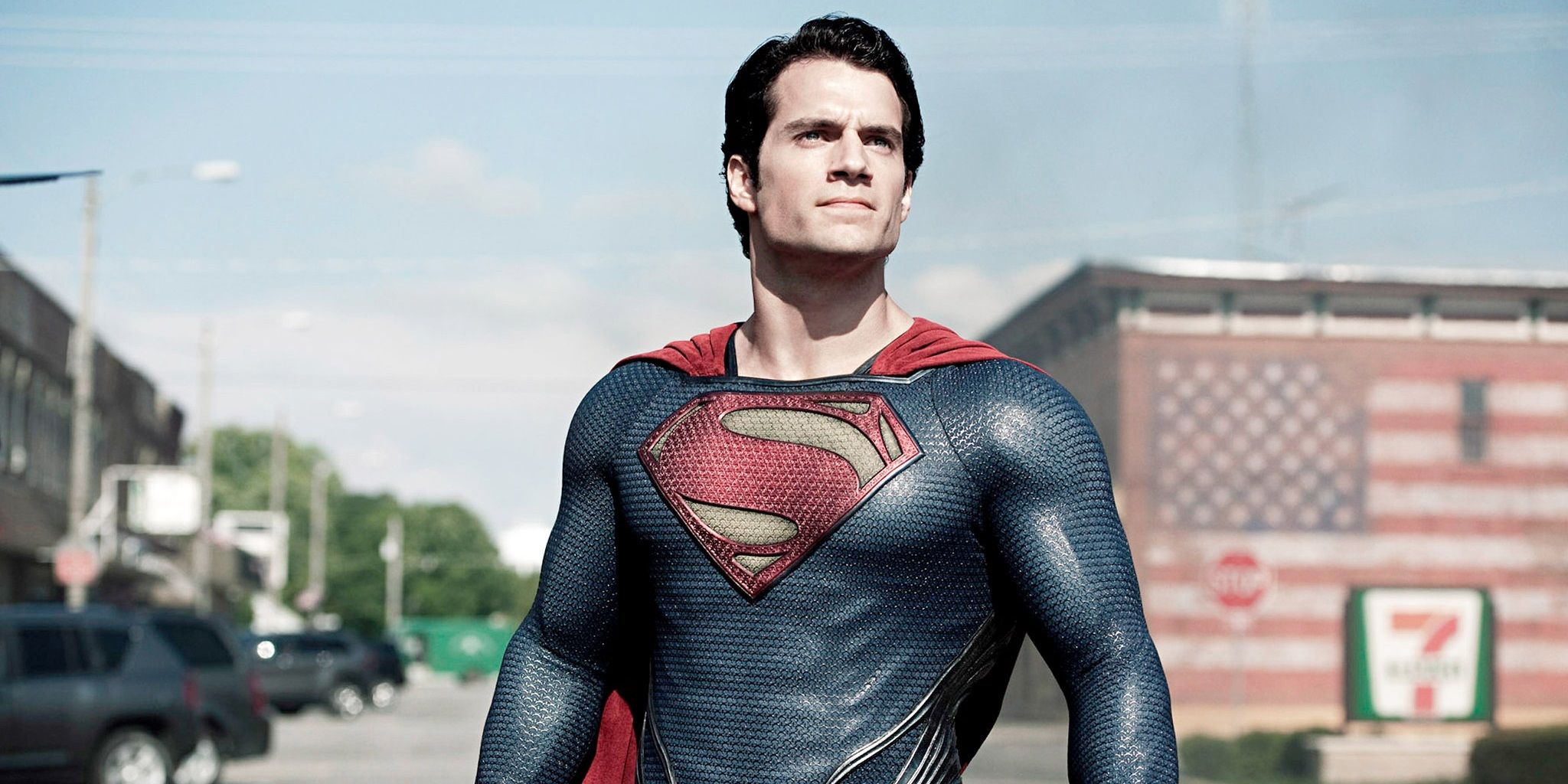 Superman standing in the middle of a street and looking to the distance in Man of Steel.