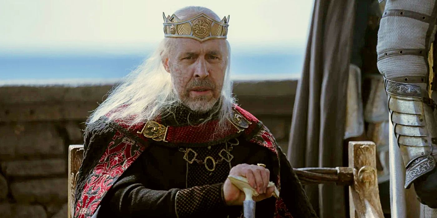   Rei Viserys sentado na Casa do Dragão 
